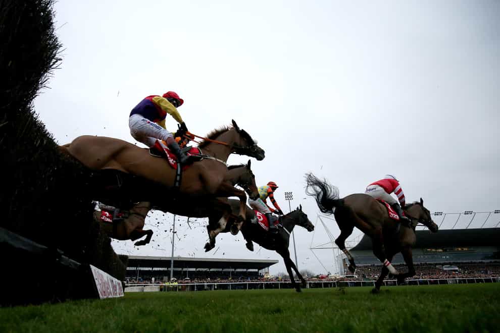 Runners clear an early fence in the King George (Julian Herbert/PA)