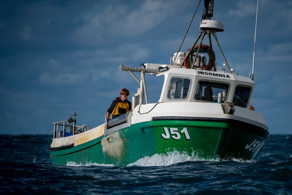 Fishermen process their catch of on the deck of their boats while fishing off the coast of Jersey (Ben Birchall/PA)