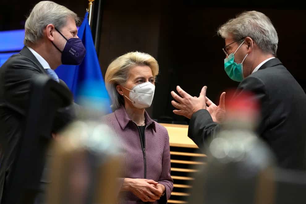European Commission President Ursula von der Leyen, centre, speaks with European Commissioner for Budget Johannes Hahn, left, and European Commissioner for Economy Paolo Gentiloni during a meeting of the College of Commissioners at EU headquarters in Brussels (Virginia Mayo/AP)
