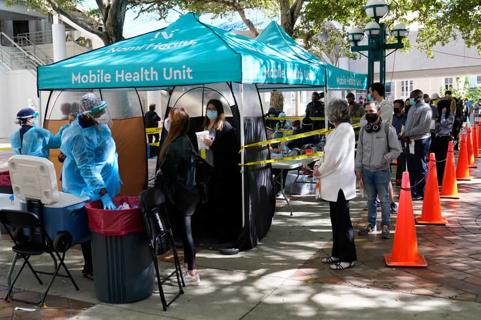 People queue up to get tested for Covid-19 in Miami (Wilfredo Lee/AP)