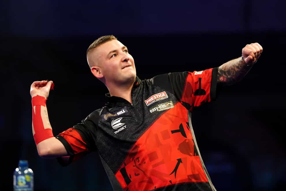 Nathan Aspinall survived a match dart to reach the third round of the PDC World Championship (Zac Goodwin/PA)