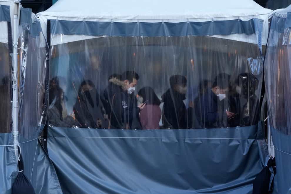 People queue to be tested for Covid at a centre in Seoul (AP Photo/Ahn Young-joon)