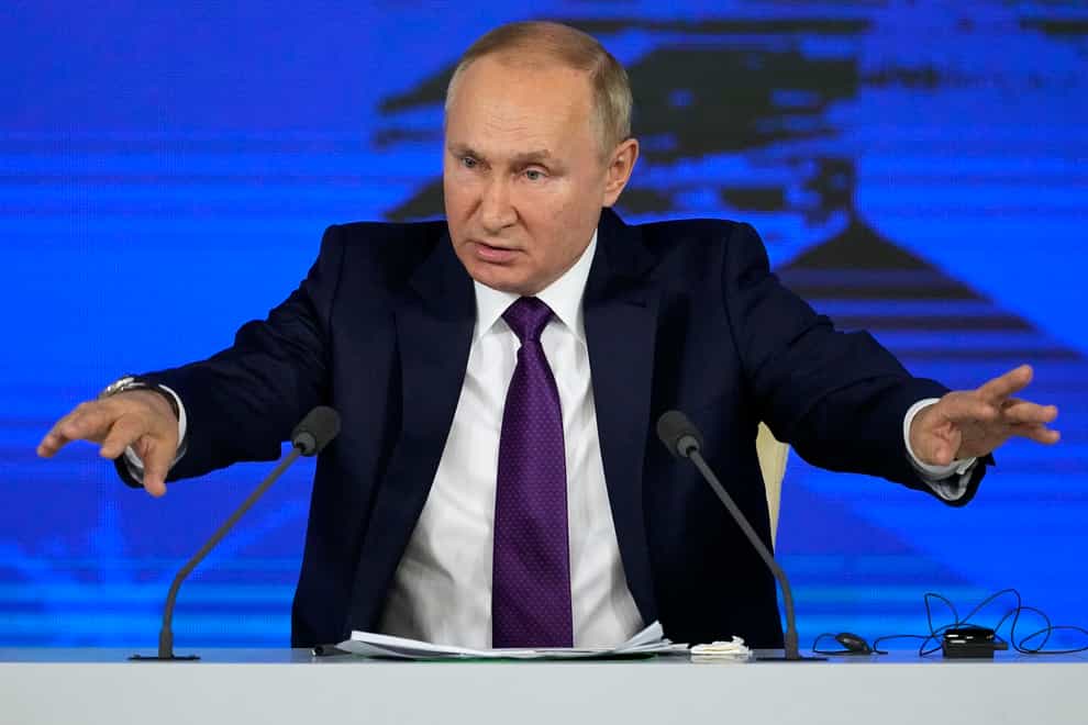 Russian President Vladimir Putin gestures while speaking during his annual news conference in Moscow (Alexander Zemlianichenko/AP)
