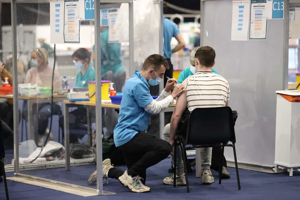 People get Covid-19 vaccinations at the Titanic Exhibition Centre in Belfast (Liam McBurney/PA)