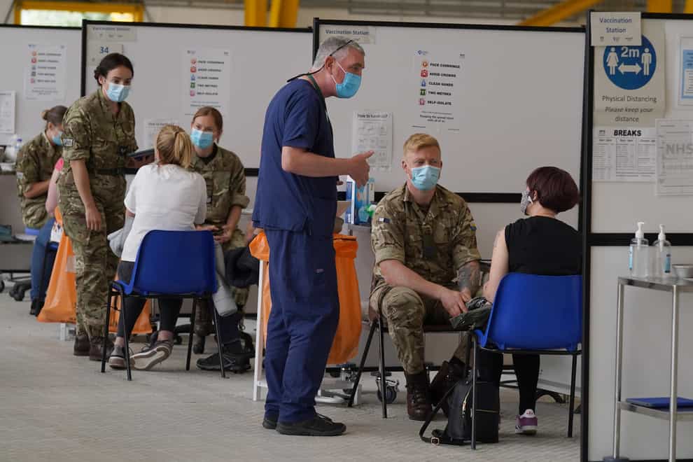 Members of the Armed Forces administer jabs at the vaccination centre at Ravenscraig Regional Sports Facility in Motherwell, Scotland (Andrew Milligan/PA)