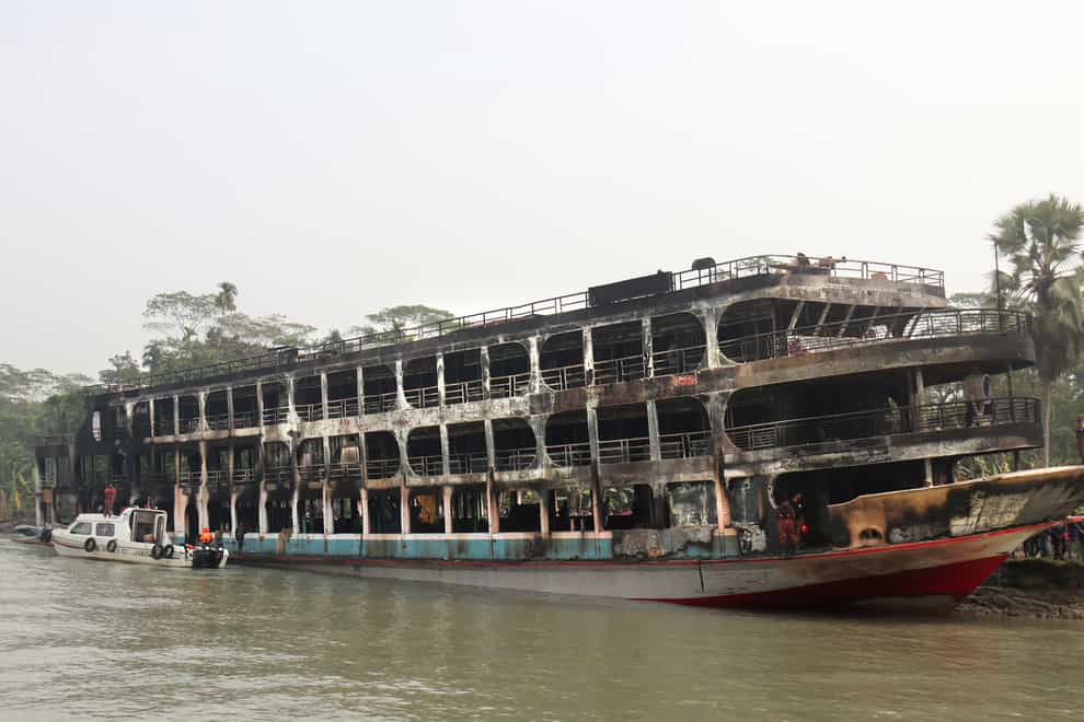The burnt passenger ferry anchored off the coast of Jhalokati district (AP)