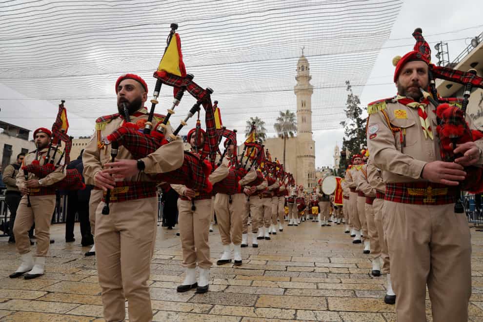 Palestinian bagpipers play as part of a parade to celebrate Christmas in Manager Square, Bethlehem (AP Photo/Mahmoud Illean)
