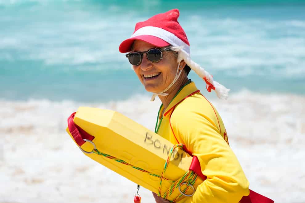 A lifesaver dons a Santa hat (Rick Rycroft/AP)