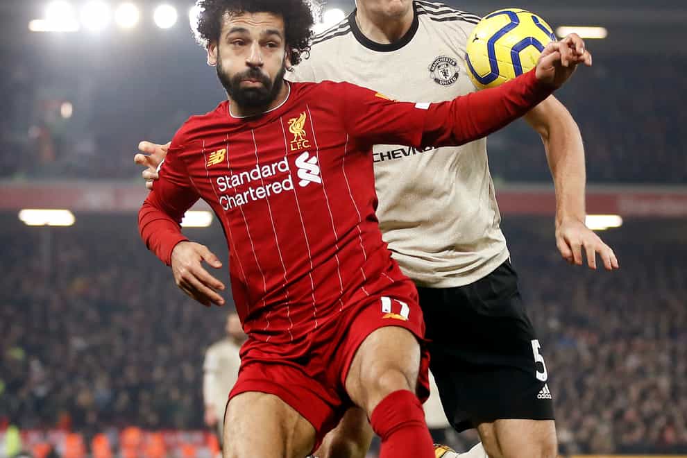 Liverpool’s Mohamed Salah (left) and Manchester United’s Harry Maguire battle for the ball (Martin Rickett/PA).