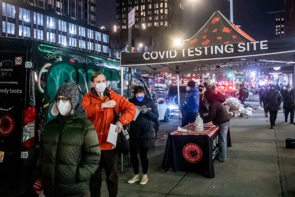 People wait in line to get tested for Covid-19 on the Lower East Side of Manhattan in New York (Brittainy Newman/AP)