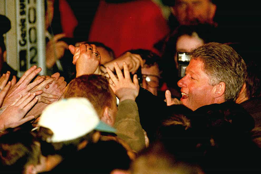 The President of the United States Bill Clinton reaches out to a sea of hands as he leaves Belfast City hall after switching on the Christmas tree lights (Adam Butler/PA)