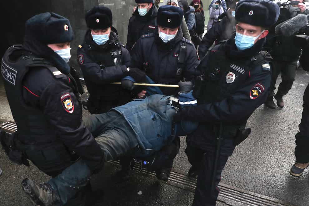 Police detain a demonstrator in front of the Supreme Court in Moscow (AP)
