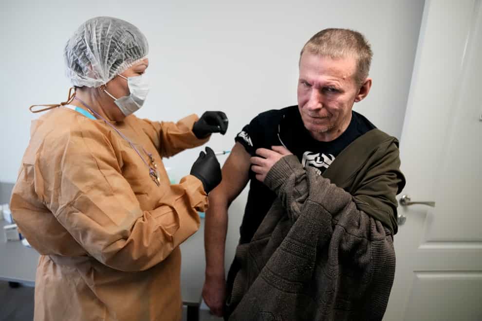 A medical worker administers a dose of Russia’s Sputnik Light Covid-19 vaccine to a homeless man in Moscow (AP Photo/Alexander Zemlianichenko)