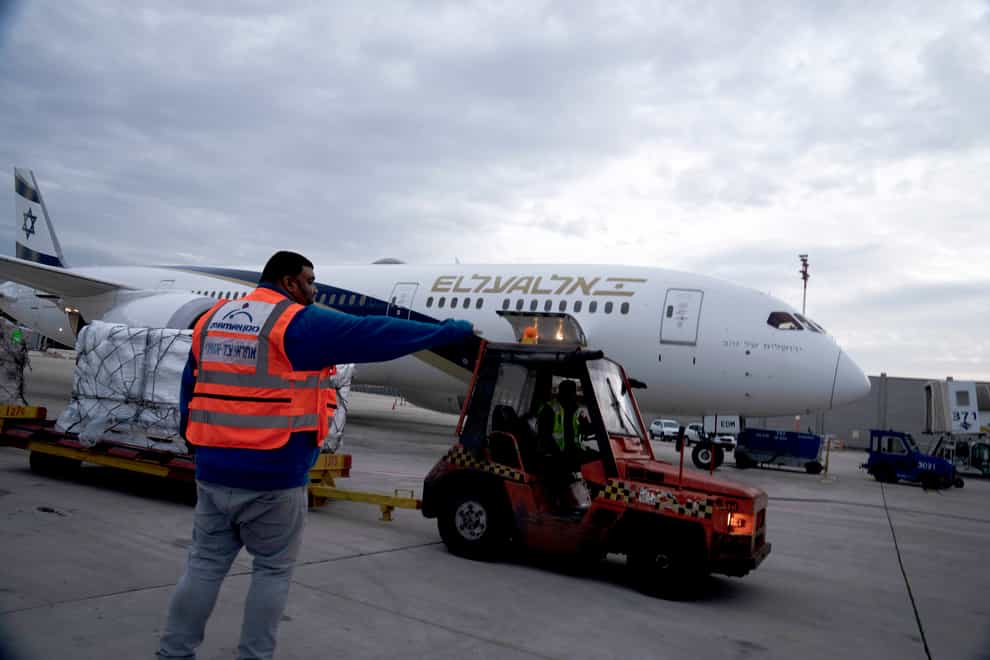 Airport workers move a shipment of Pfizer’s anti-viral Covid-19 pill, Paxlovid, at Ben Gurion International airport (Maya Alleruzzo/AP)