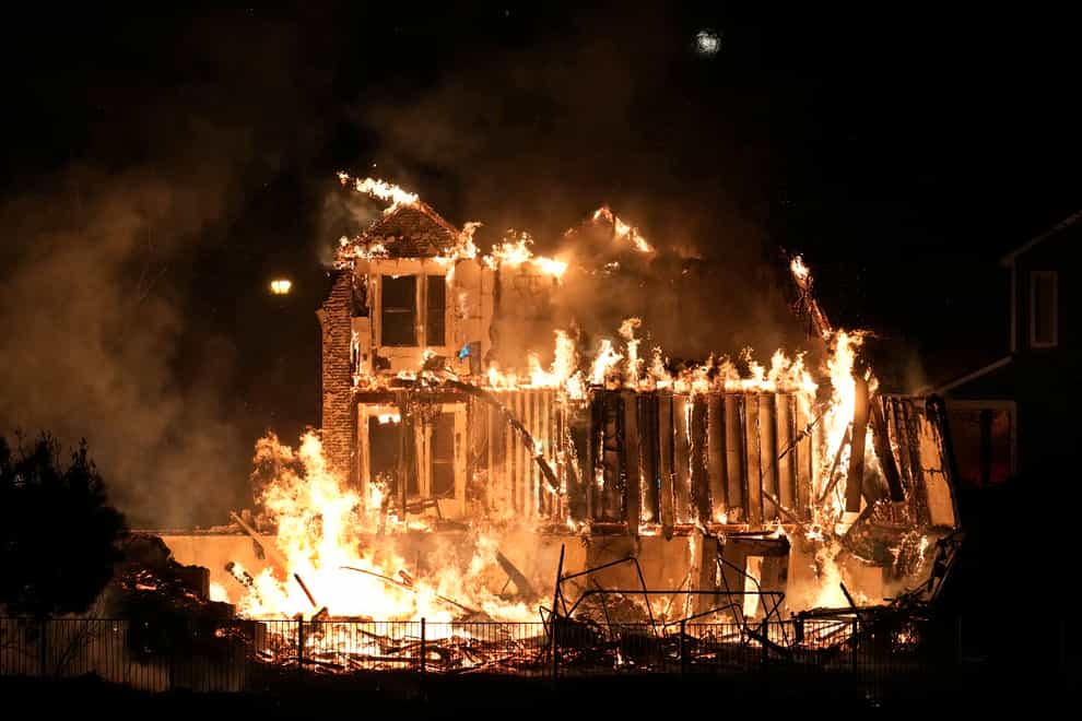 Homes burn as a wildfire rips through a development near Rock Creek Village, Colorado (AP Photo/David Zalubowski)