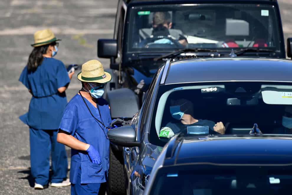 Health care workers administer Covid-19 tests at a drive-through clinic in Sydney (AAP via AP)