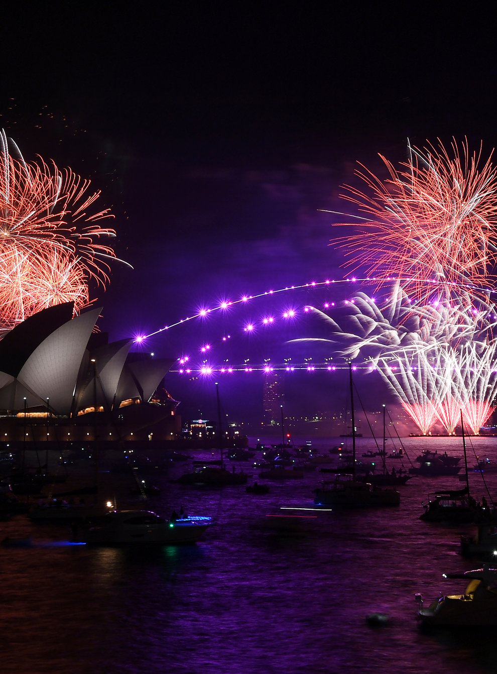 Fireworks explode over Sydney Opera House and Harbour Bridge as New Year’s Eve celebrations begin in Sydney, Friday, Dec. 31, 2021. (Dean Lewins/AAP Image via AP)