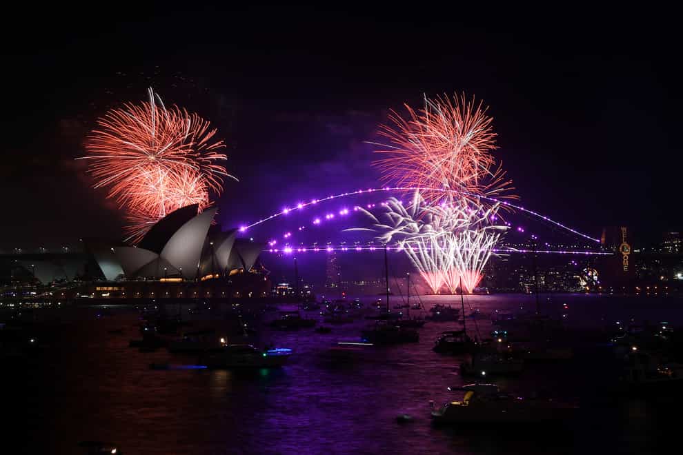 Fireworks explode over Sydney Opera House and Harbour Bridge as New Year’s Eve celebrations begin in Sydney, Friday, Dec. 31, 2021. (Dean Lewins/AAP Image via AP)