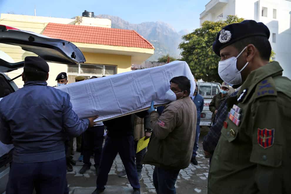 Health workers carry the coffin of a victim of a deadly stampede at the Mata Vaishnav Devi shrine in Katra, India (Channi Anand/AP)