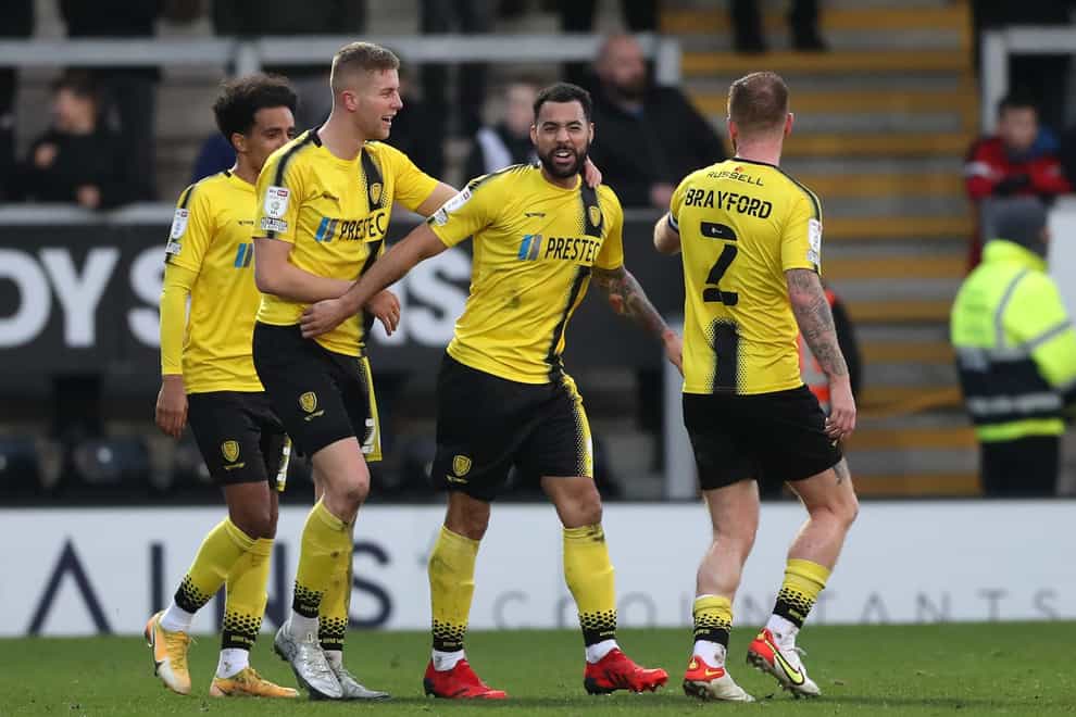 Burton’s Kane Hemmings (second from right) celebrates with team-mates after scoring in a 4-1 over Crewe