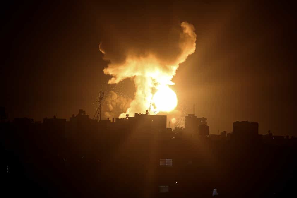 An explosion caused by Israeli airstrikes is seen in the town of Khan Younis (Yousef Masoud/AP/PA)