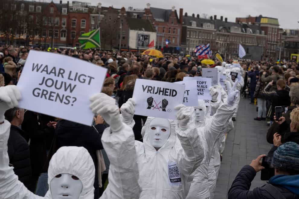 A sign reads “Vrijheid” or “Freedom” as thousands of people protested in Amsterdam on Sunday (Peter Dejong/AP)