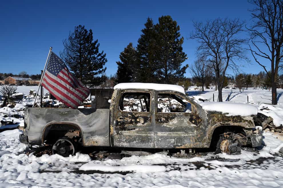A burned truck in a destroyed neighbourhood in Louisville (Thomas Peipert/AP)