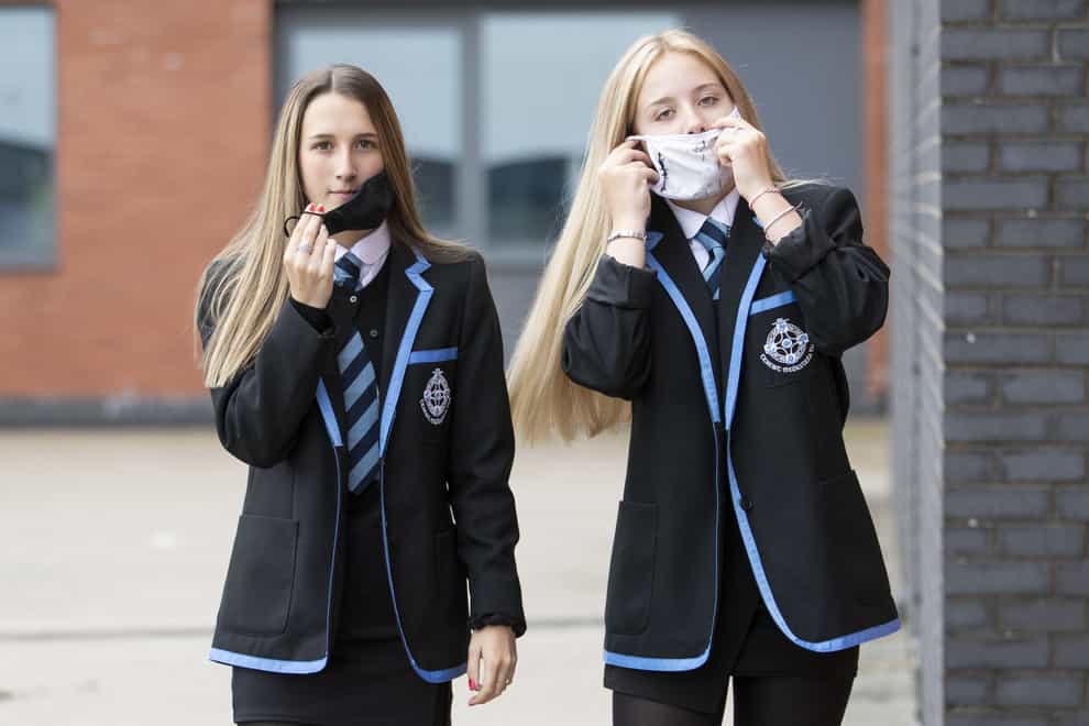 Leah McCallum (left) and Rebecca Ross, S4 students at St Columba’s High School, Gourock, put on their protective face masks as the requirement for secondary school pupils to wear face coverings when moving around school comes into effect from today across Scotland.