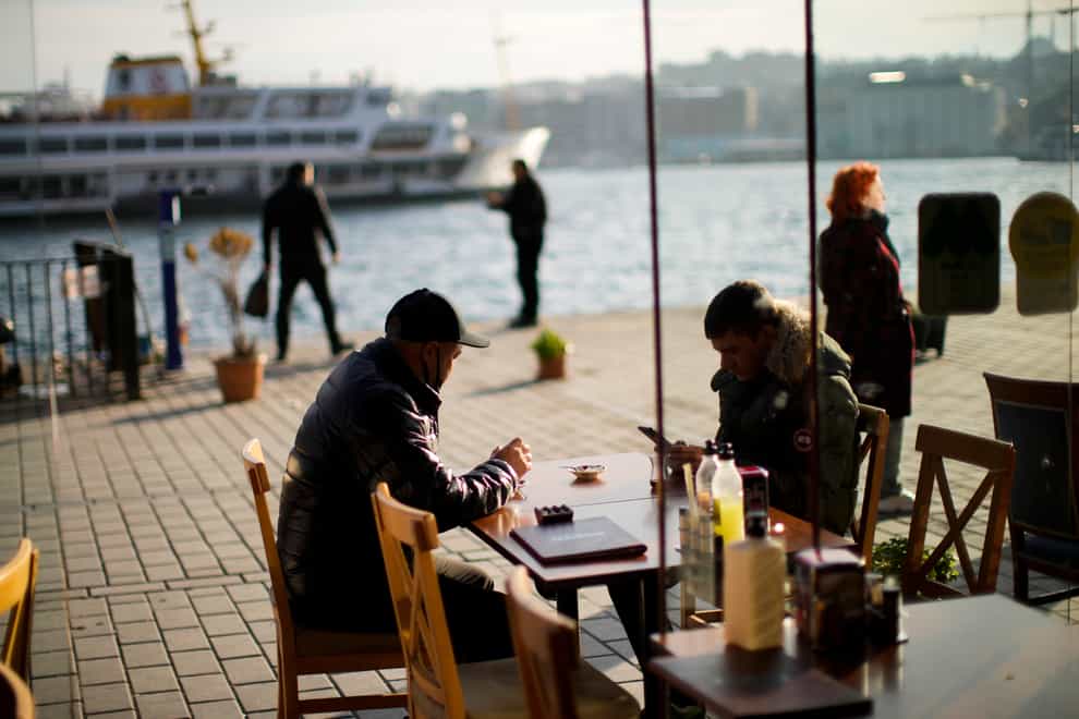 Clients drink tea in a local restaurant in Karakoy ferry terminal in Istanbul (Francisco Seco/AP)