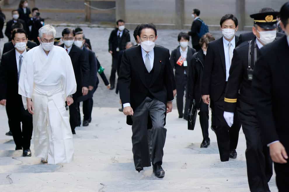 Fumio Kishida, centre, visits Ise Shrine in Ise in central Japan (Kyodo news via AP)