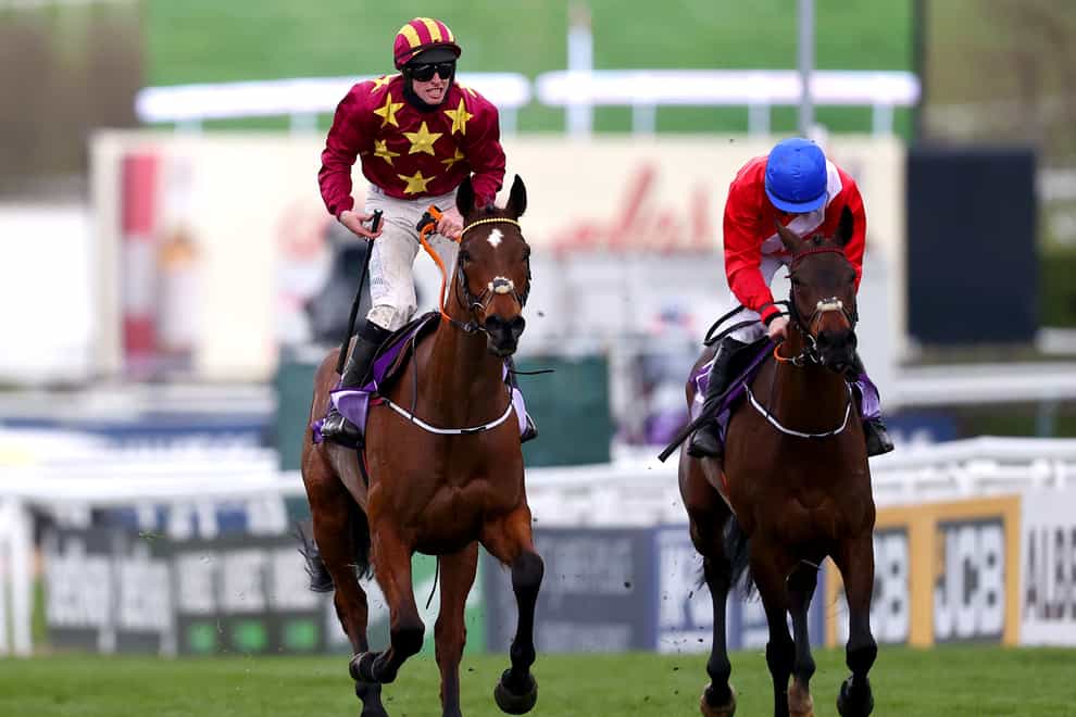 Jack Kennedy (left) celebrates on top of Minella Indo after winning the WellChild Cheltenham Gold Cup (Michael Steele/PA)