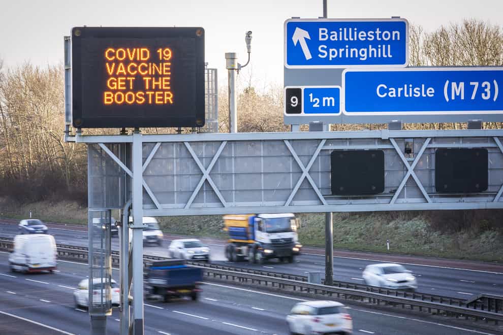 Information signs above the M8 motorway in Glasgow read ‘Covid 19 Vaccine Get the Booster’ (Jane Barlow/PA)