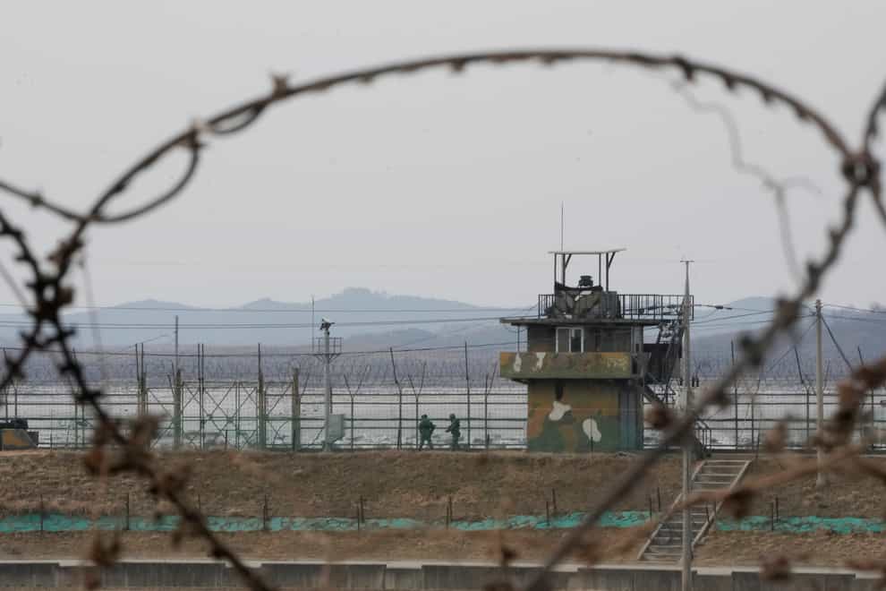 South Korean army soldiers patrol along the barbed-wire fence in Paju, near the border with North Korea (Ahn Young-joon/AP)