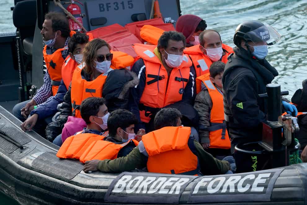 People are brought in to Dover, Kent, by Border Force officers (Gareth Fuller/PA)
