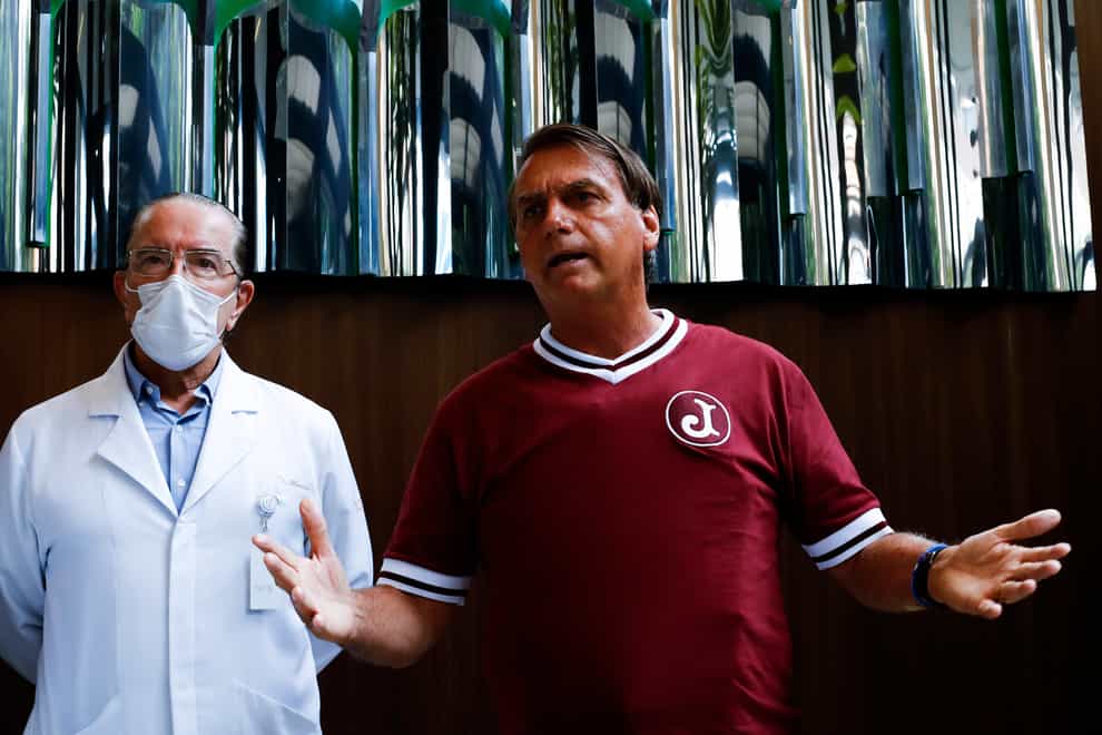 Brazilian President Jair Bolsonaro, right, and his personal doctor, Antonio Luiz Macedo, give a press conference after the president was discharged from hospital in Sao Paulo (Marcelo Chello/AP)