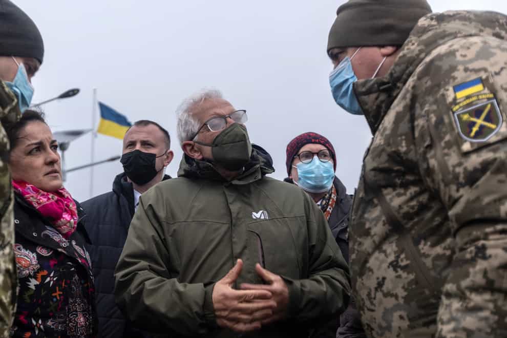 European Union foreign policy chief Josep Borrell chats with Ukrainian soldiers during his visit to a border crossing between Ukraine and the territory controlled by pro-Russia militants in the Luhansk region (Andriy Dubchak/AP)