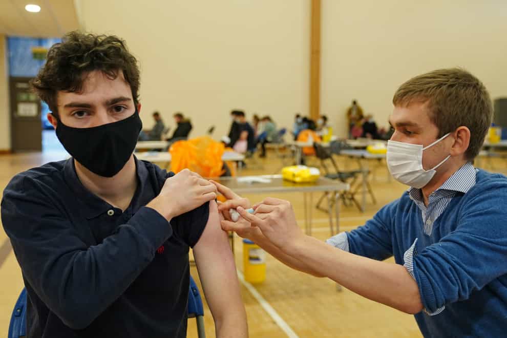 Matthew Bell (left) receives his Covid-19 vaccine from Ross Aitchison, during a vaccination clinic at the Glasgow Central Mosque (Jane Barlow/PA)