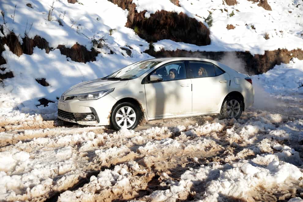 Hundreds of vehicles became buried or stranded in heavy snow in the Murree Hills area of Pakistan (Rahmat Gul/AP)
