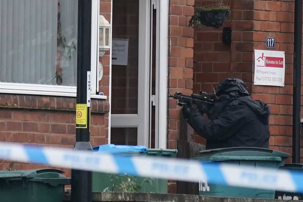 An armed police officer outside a property in Earlsdon Avenue North, Coventry, where police remain in a stand-off with a man (Jacob King/PA)