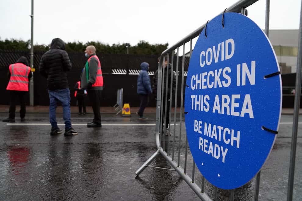Staff check the Covid passports of supporters ahead of the Emirates FA Cup third round match at Turf Moor, Burnley (Martin Rickett/PA)