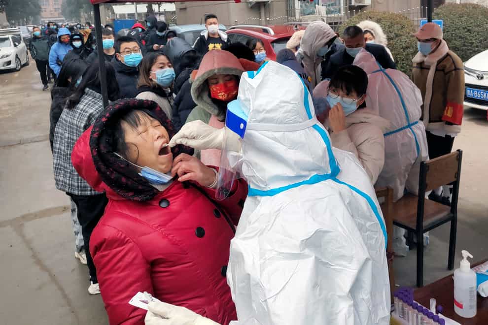 Swab samples for the Covid-19 test on residents in Huaxian county in central China’s Henan province (Chinatopix via AP)