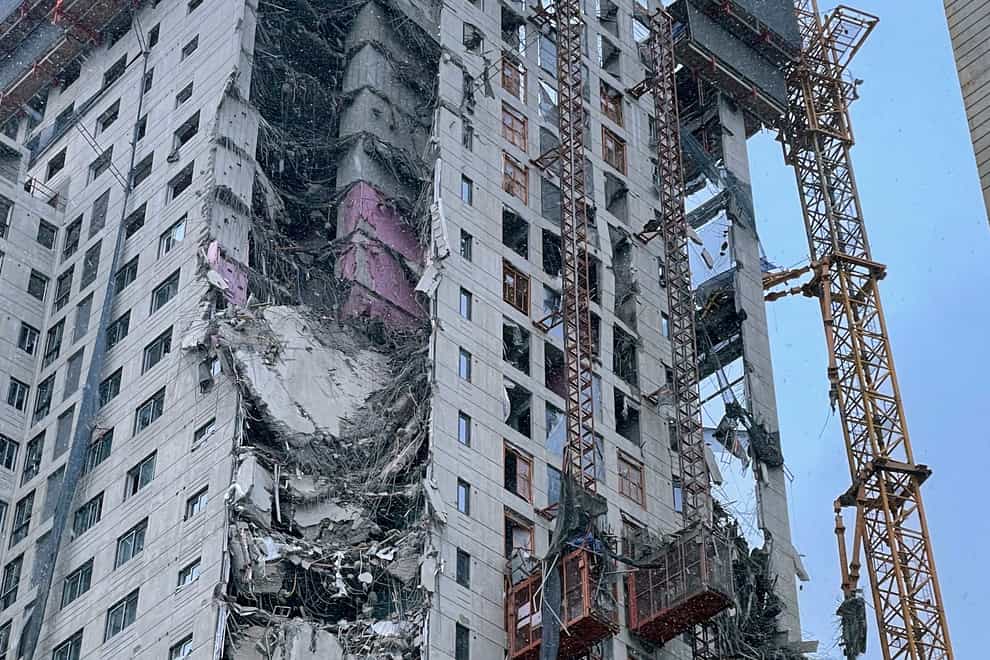 The exterior wall of an apartment under construction is seen collapsed at a site in Gwangju, South Korea, Tuesday, Jan. 11, 2022. South Korean emergency officials on Tuesday said that at least six people were missing and more than 100 households were forced to evacuate following the partial collapse of a high-rise apartment building that was under construction in the city of Gwangju. (Chung Hoe-sung /Yonhap via AP)