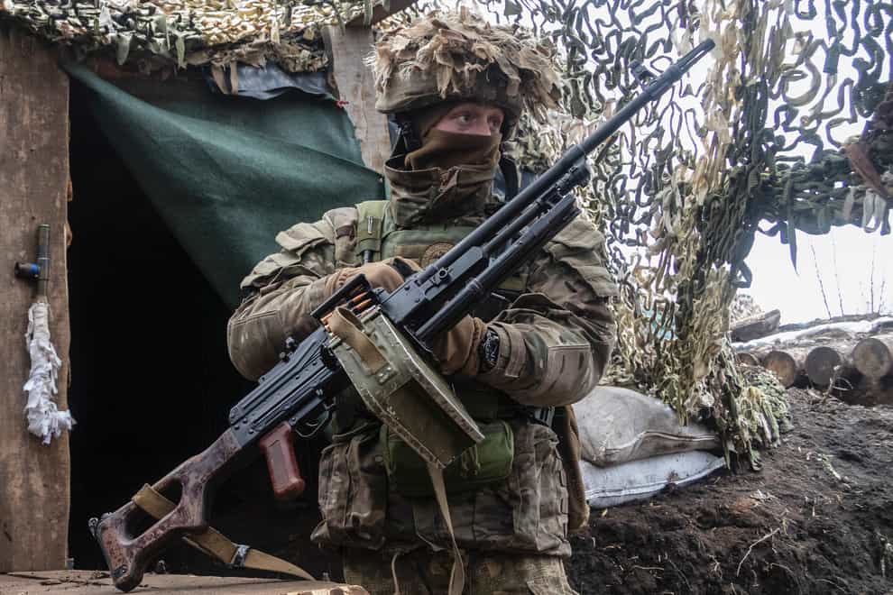 A Ukrainian soldier stands at the line of separation from pro-Russian rebels in the Donetsk region (Andriy Dubchak/AP)