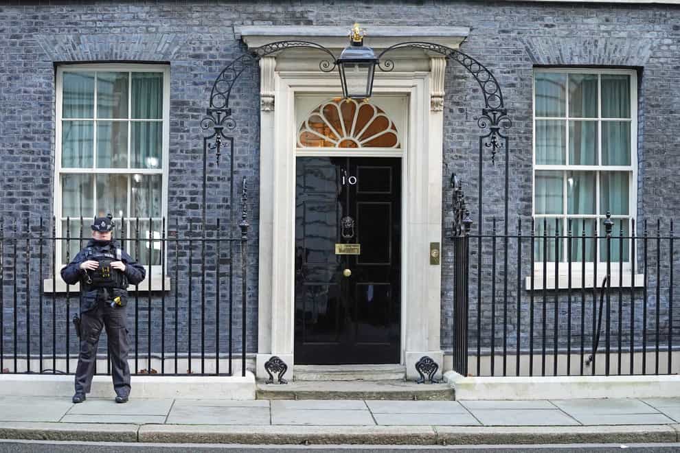 A police officer stands at the door of the Prime Minister’s official residence in Downing Street, Westminster, London, as public anger continues following the leak on Monday of an email from Boris Johnson’s principal private secretary, Martin Reynolds, inviting 100 Downing Street staff to a “bring your own booze” party in the garden behind No 10 during England’s first lockdown on May 20, 2020. Picture date: Wednesday January 12, 2022. (Stefan Rousseau/PA)