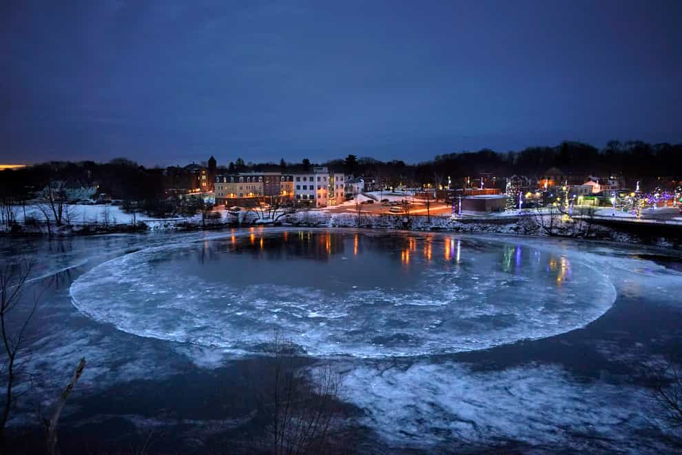 A large ice disc slowly rotates in the Presumpscot River in Westbrook, Maine (Robert F Bukaty/AP)