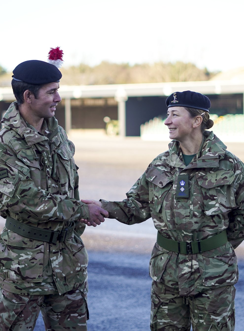 Lt Col Shamus Kelly shakes the hand of his wife, Lt Col Lyndsey Kelly, as he exchanges the command of 1ATR (Army Training Regiment) to her (Steve Parsons/PA)