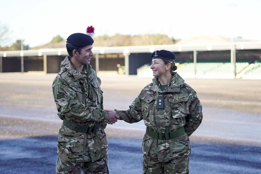 Lt Col Shamus Kelly shakes the hand of his wife, Lt Col Lyndsey Kelly, as he exchanges the command of 1ATR (Army Training Regiment) to her (Steve Parsons/PA)