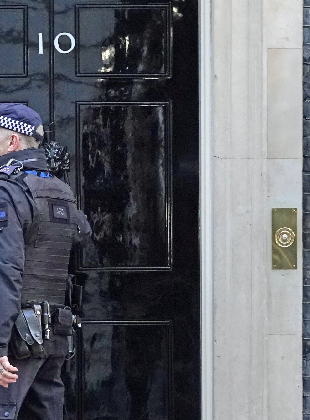 A police officer knocks on the door of the Prime Minister’s official residence in Downing Street, Westminster, London, as public anger continues following the leak on Monday of an email from Boris Johnson’s principal private secretary, Martin Reynolds, inviting 100 Downing Street staff to a “bring your own booze” party in the garden behind No 10 during England’s first lockdown on May 20, 2020. Picture date: Wednesday January 12, 2022. (Stefan Rousseau/PA)