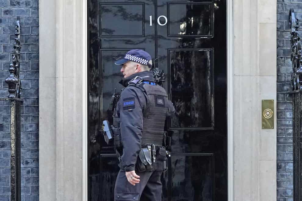 A police officer knocks on the door of the Prime Minister’s official residence in Downing Street, Westminster, London, as public anger continues following the leak on Monday of an email from Boris Johnson’s principal private secretary, Martin Reynolds, inviting 100 Downing Street staff to a “bring your own booze” party in the garden behind No 10 during England’s first lockdown on May 20, 2020. Picture date: Wednesday January 12, 2022. (Stefan Rousseau/PA)