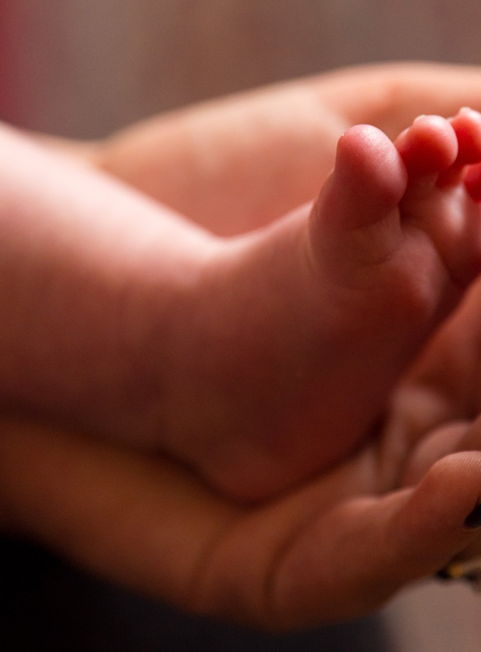 Undated file photo of a mother holding the feet of a new baby (Dominic Lipinski/PA)